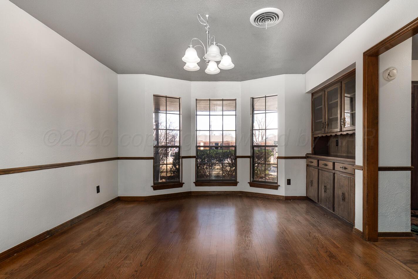 7803 Farrell Drive Amarillo, TX 79121 - Photo 12 of 29 a view of a kitchen with a stove wooden floor and a kitchen