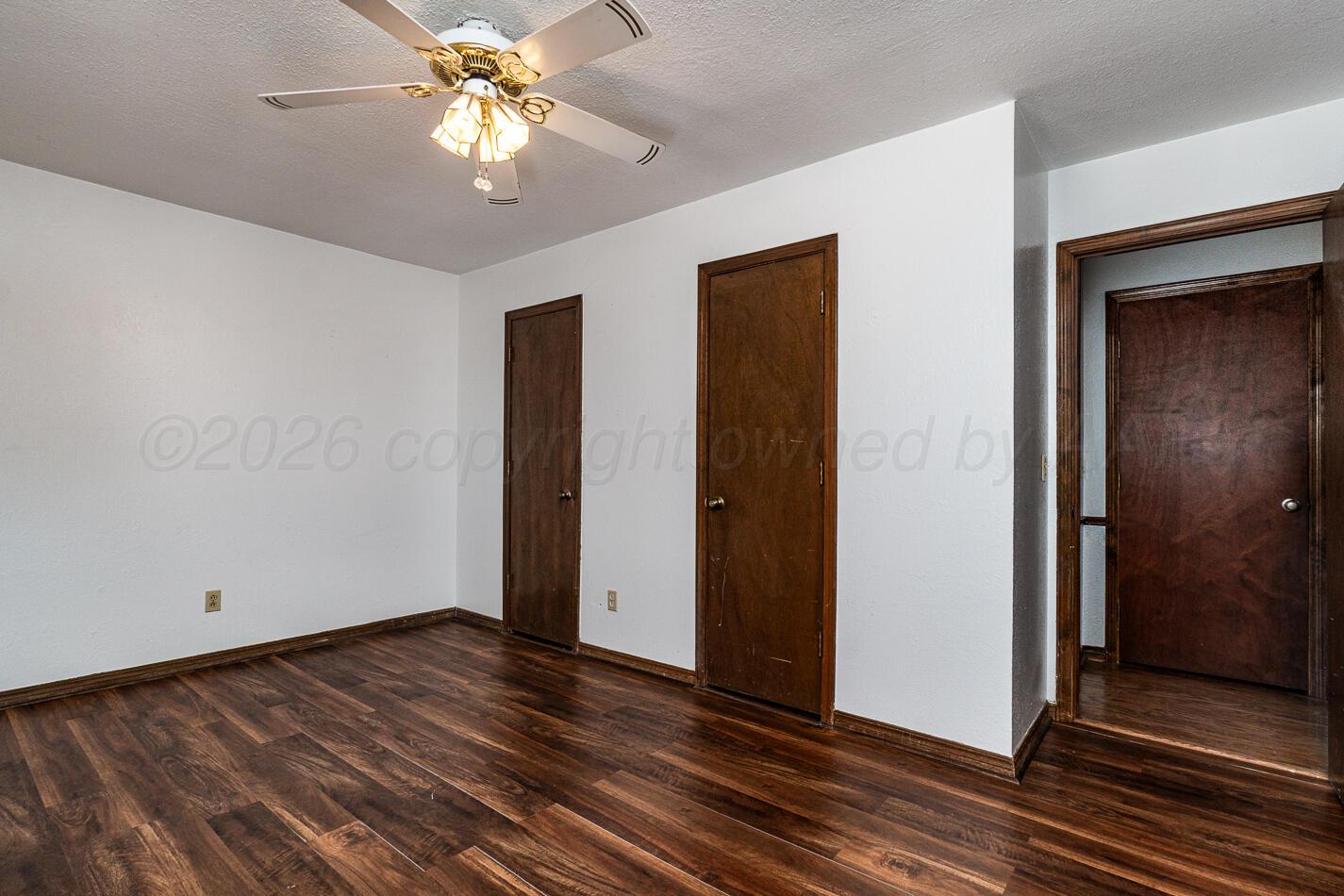 7803 Farrell Drive Amarillo, TX 79121 - Photo 14 of 29 a view of a room with wooden floor and a ceiling fan