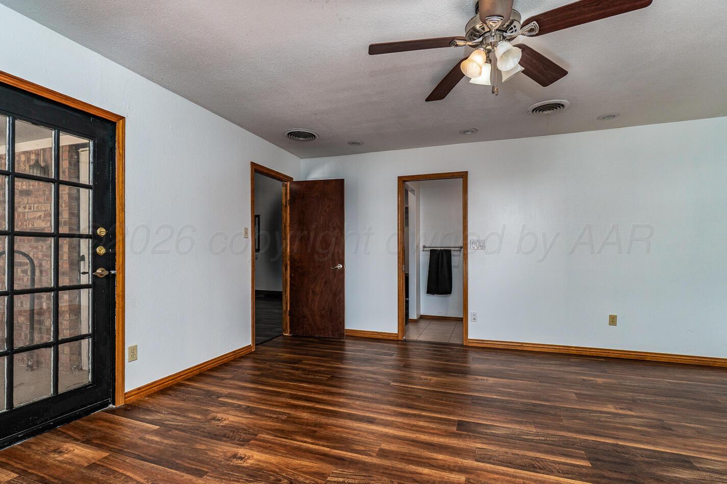7803 Farrell Drive Amarillo, TX 79121 - Photo 19 of 29 wooden floor in an empty room with a window