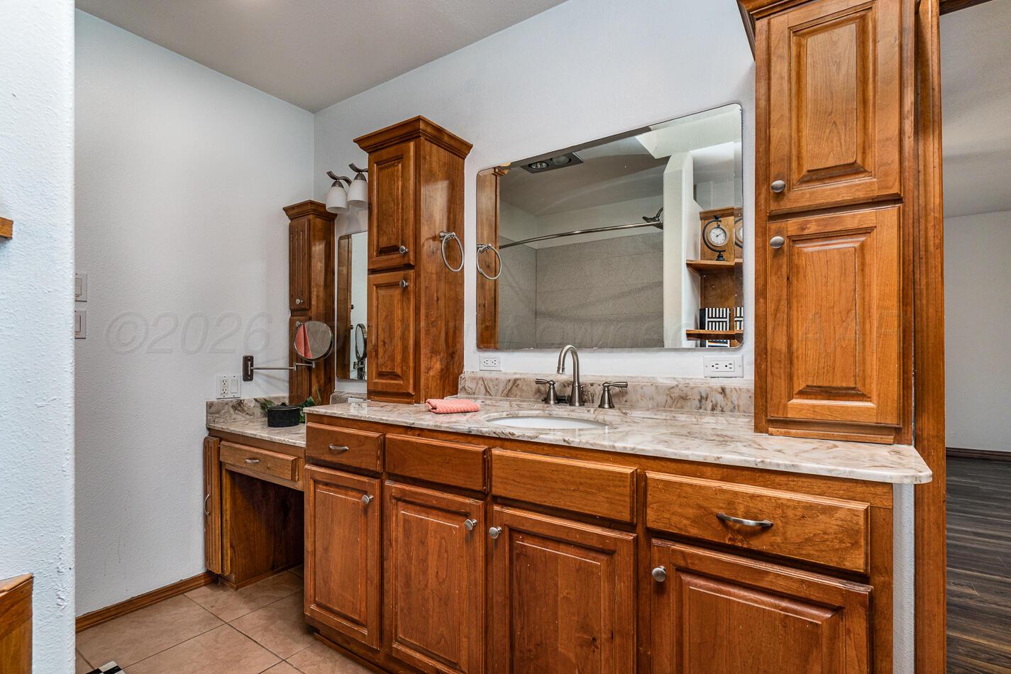 7803 Farrell Drive Amarillo, TX 79121 - Photo 20 of 29 a bathroom with a sink and a mirror