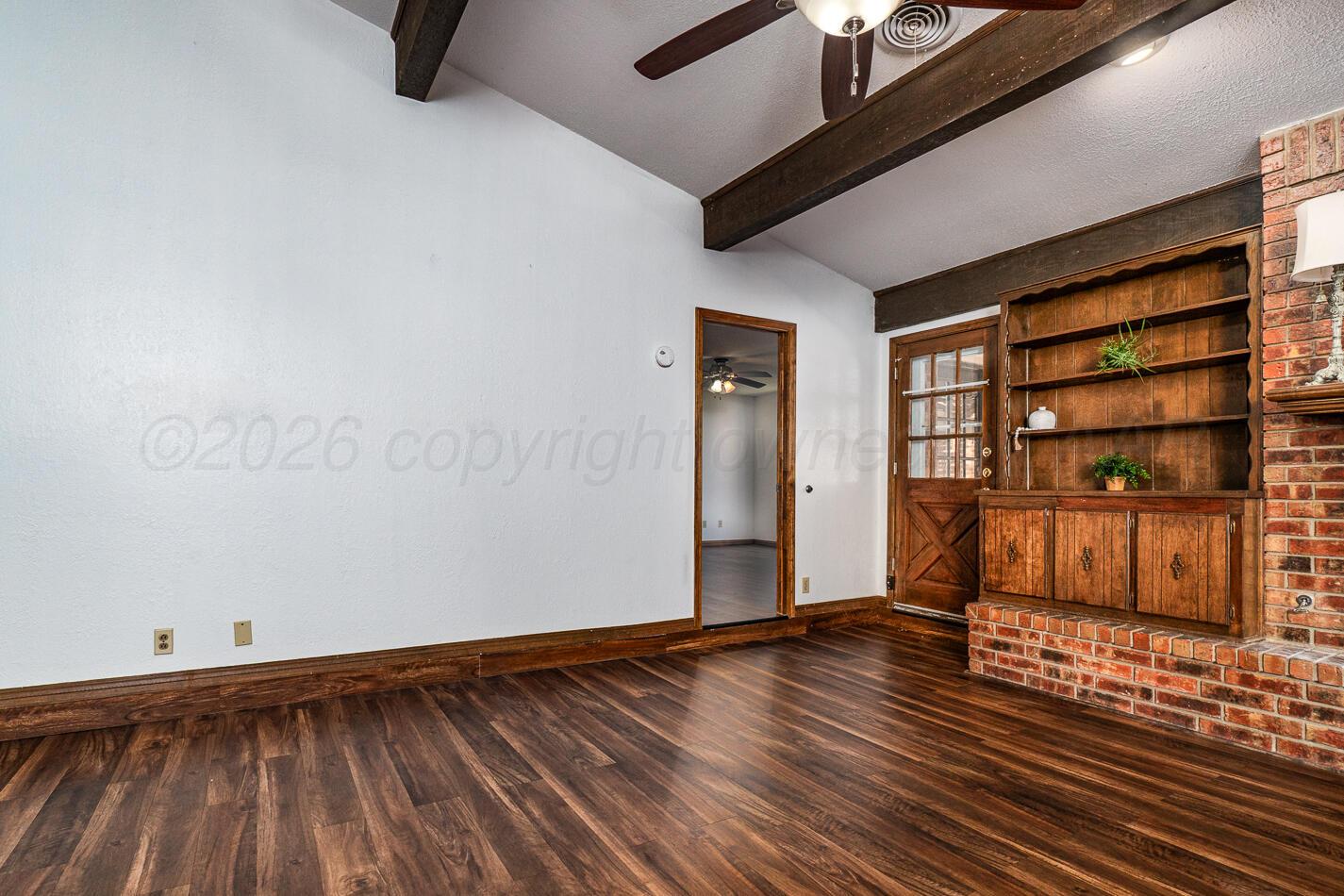 7803 Farrell Drive Amarillo, TX 79121 - Photo 5 of 29 a view of an empty room with wooden floor and a window