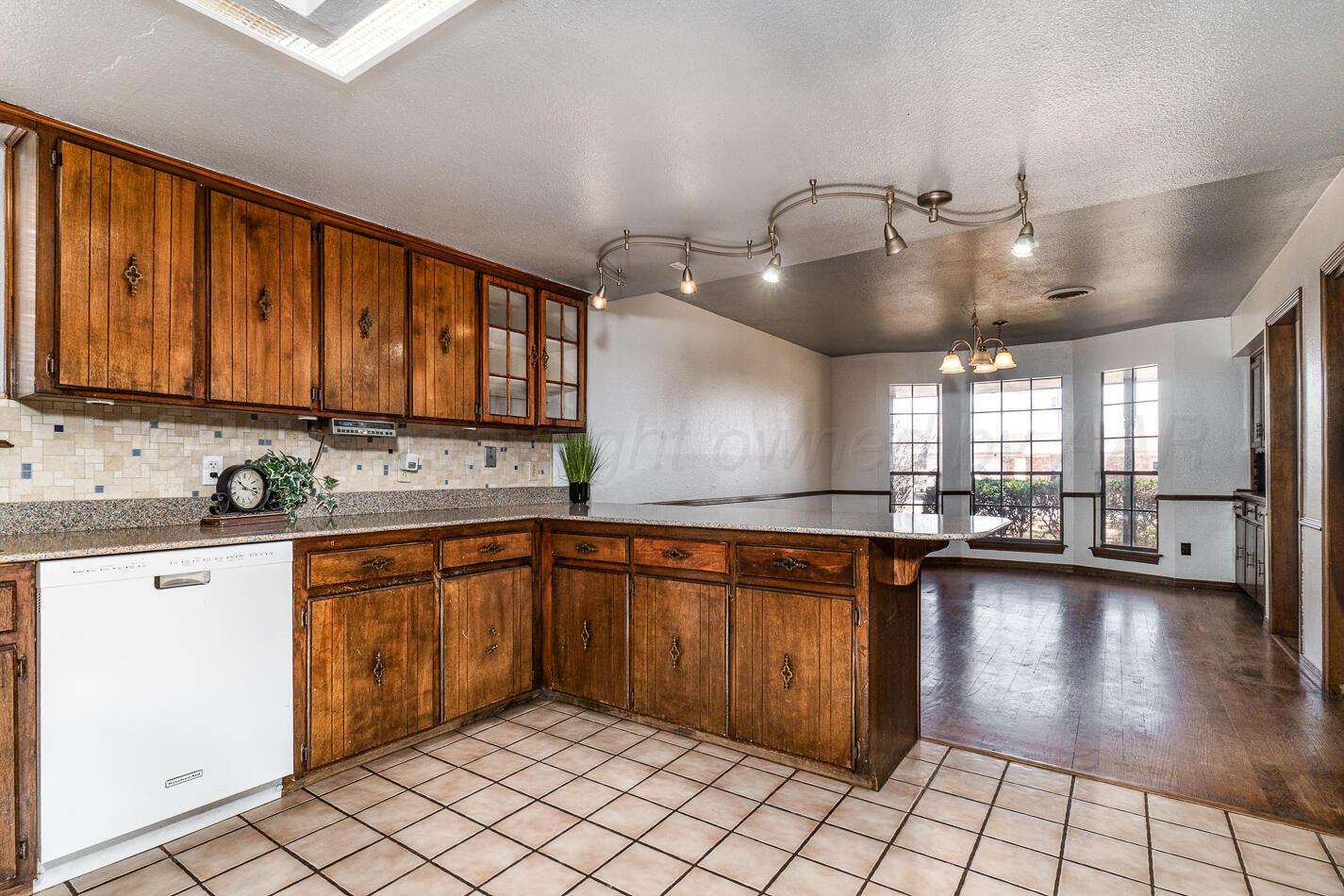 7803 Farrell Drive Amarillo, TX 79121 - Photo 7 of 29 a large kitchen with lots of counter space