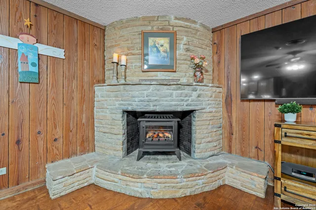 a view of living room with furniture and a fireplace