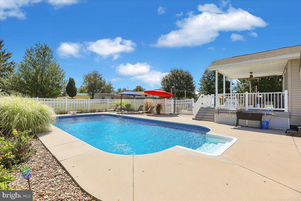 41 Michelle Way Hanover, PA 17331 - Photo 41 of 49 a view of a swimming pool with a lounge chair and floor to ceiling window