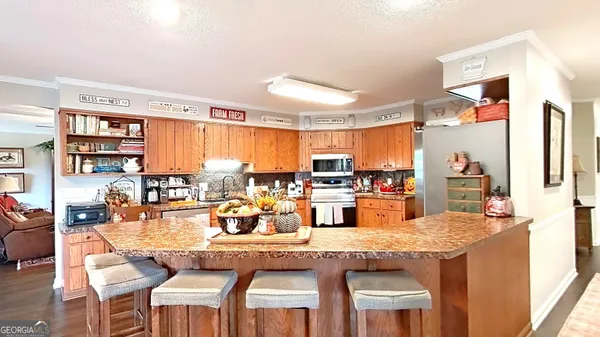 a bedroom with a bed a chandelier and dresser