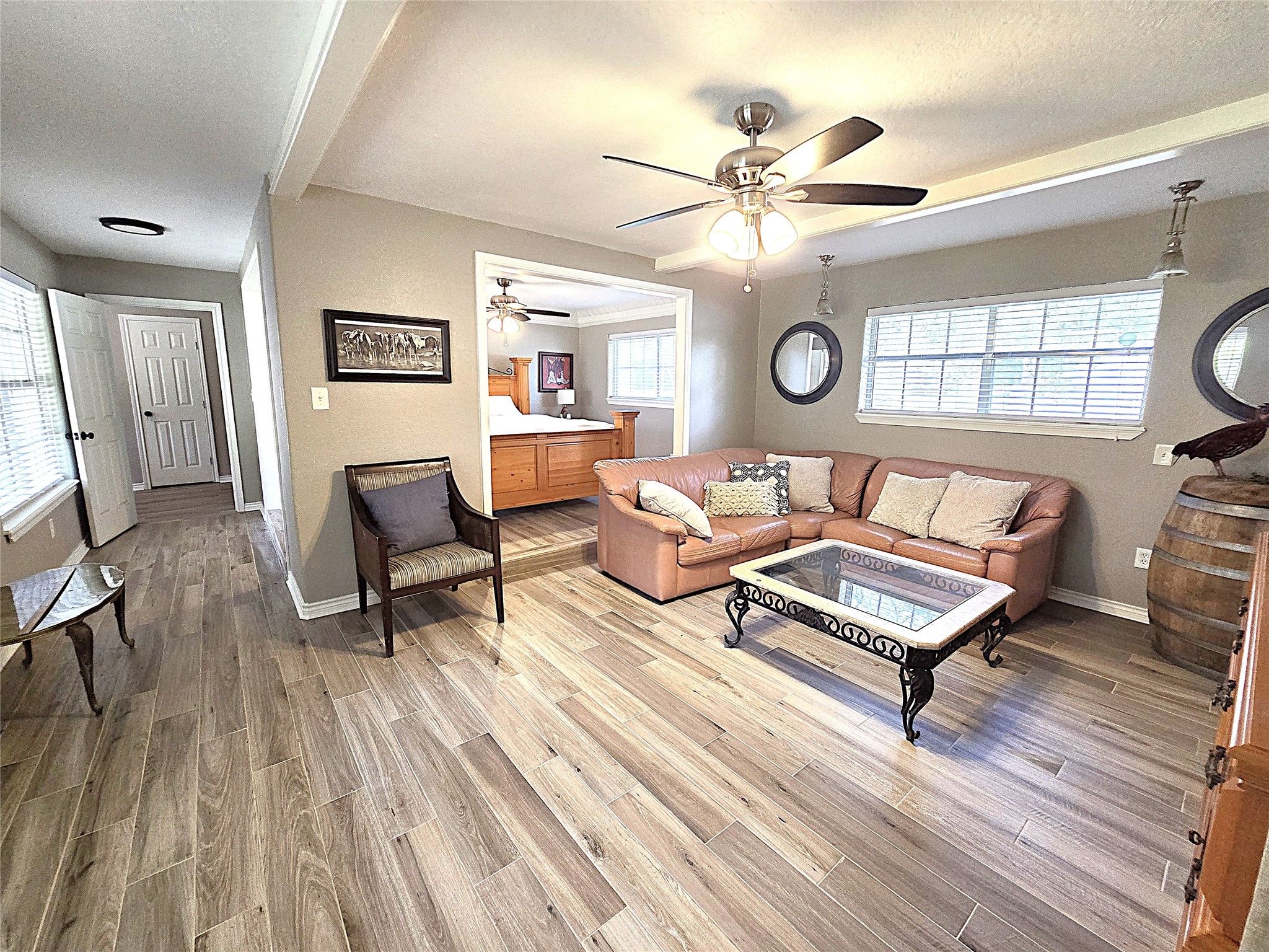 560 Brandon Road Conroe, TX 77302 - Photo 30 of 45 Spacious master suite with an inviting living area, featuring elegant flooring, abundant natural light, and a cozy seating arrangement for ultimate relaxation.