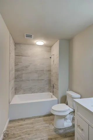 a bathroom with a bathtub and a toilet