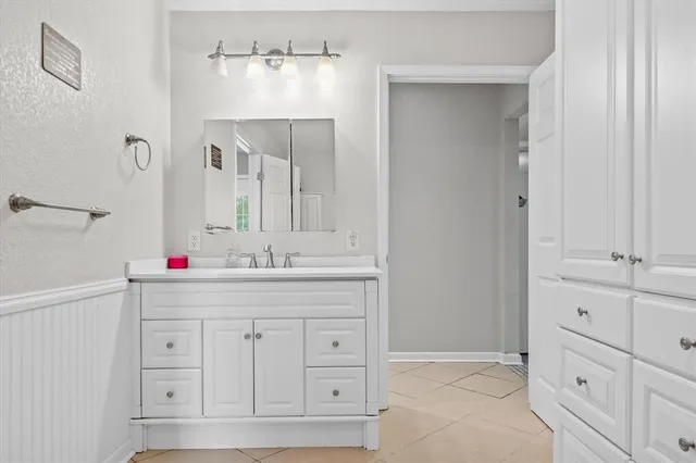 a bathroom with a sink and vanity
