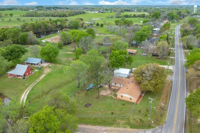 an aerial view of a house with a yard