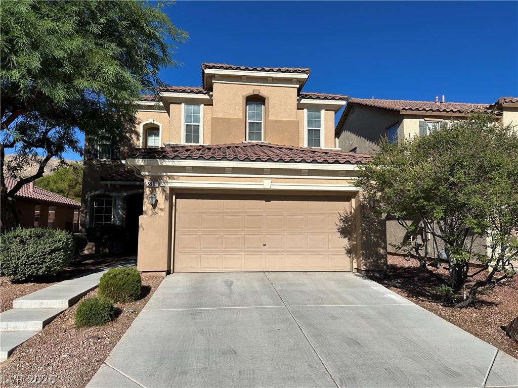 5981 Honeysuckle Ridge Street Las Vegas, NV 89148 - Photo 3 of 29 A terracotta roof and desert landscaping define this suburban dwelling.