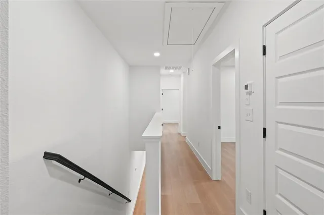 a view of a hallway with stairs