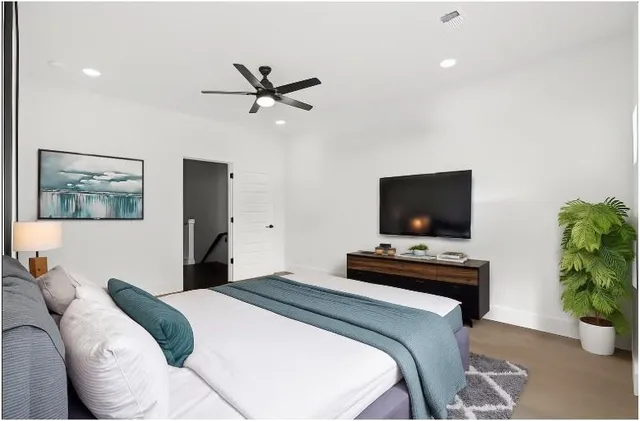 a bedroom with a bed and a flat screen tv