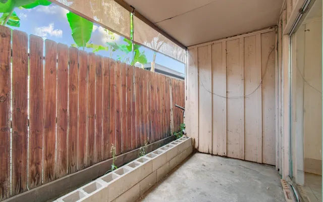 a view of a balcony with wooden fence
