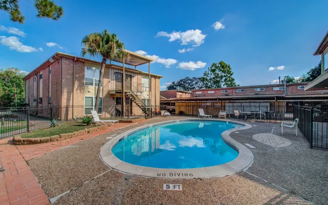 a view of a house with swimming pool and sitting area
