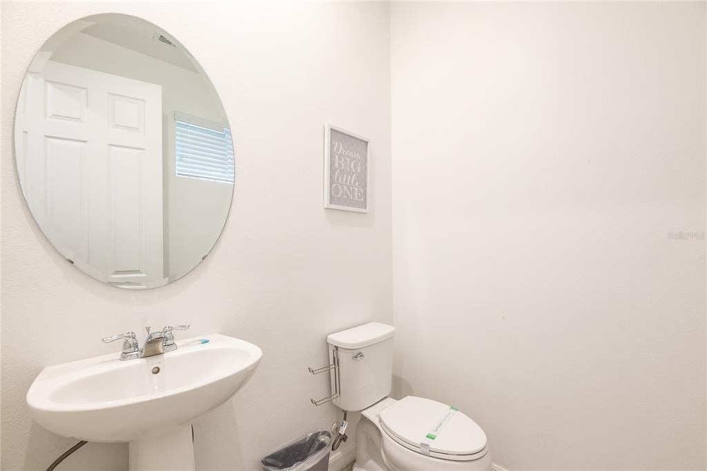 8900 Caroline Bay Court Kissimmee, FL 34747 - Photo 11 of 62 a bathroom with a toilet a sink and a mirror