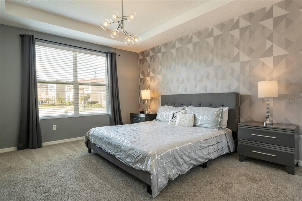 8900 Caroline Bay Court Kissimmee, FL 34747 - Photo 12 of 62 a bedroom with a bed dresser and a window