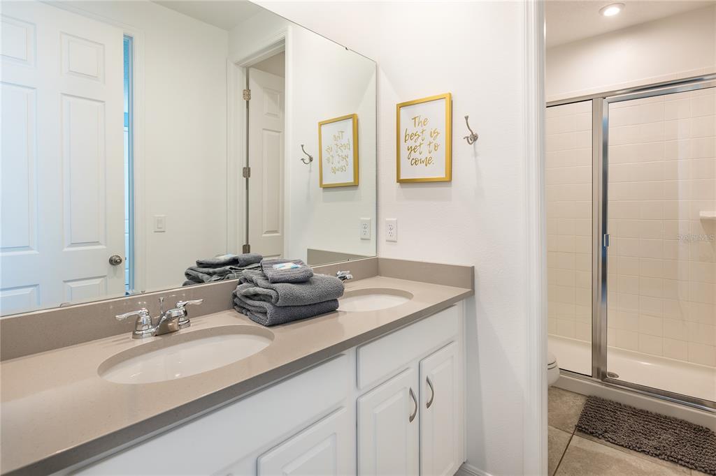 8900 Caroline Bay Court Kissimmee, FL 34747 - Photo 23 of 62 a bathroom with a sink and a mirror