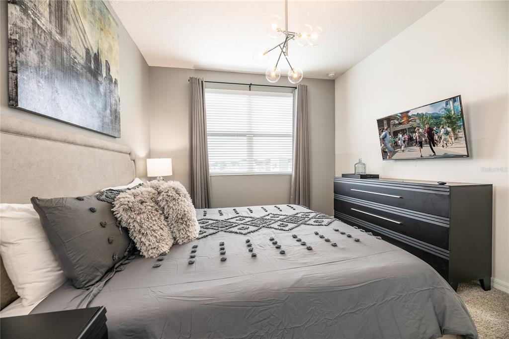8900 Caroline Bay Court Kissimmee, FL 34747 - Photo 31 of 62 a bedroom with a bed and a window