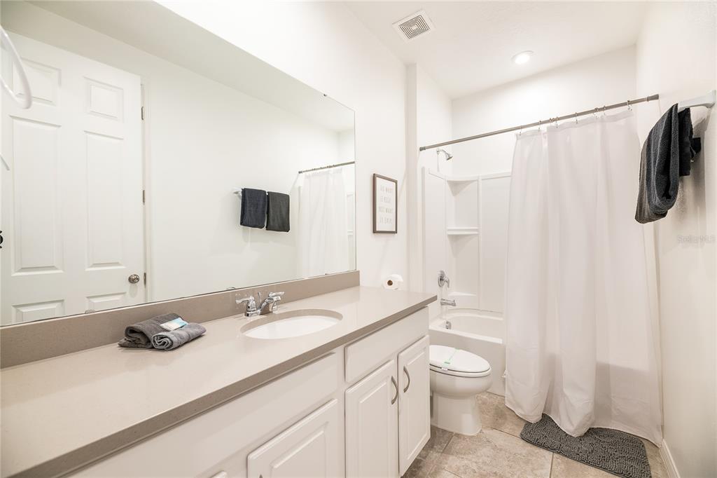 8900 Caroline Bay Court Kissimmee, FL 34747 - Photo 33 of 62 a bathroom with a sink a toilet and shower