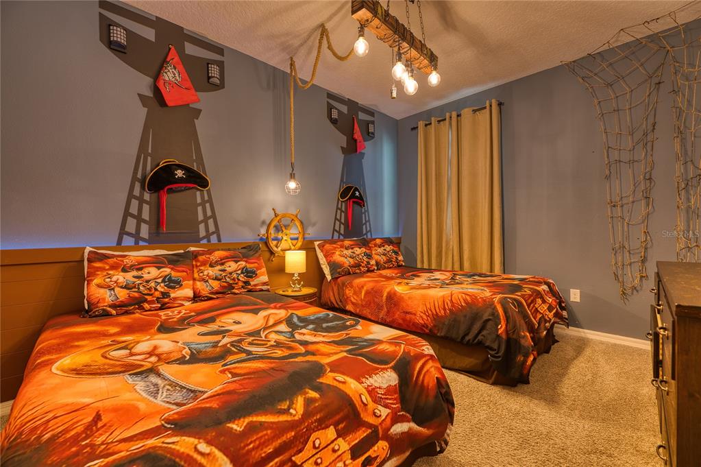 8900 Caroline Bay Court Kissimmee, FL 34747 - Photo 34 of 62 a bedroom with double bed and a chandelier