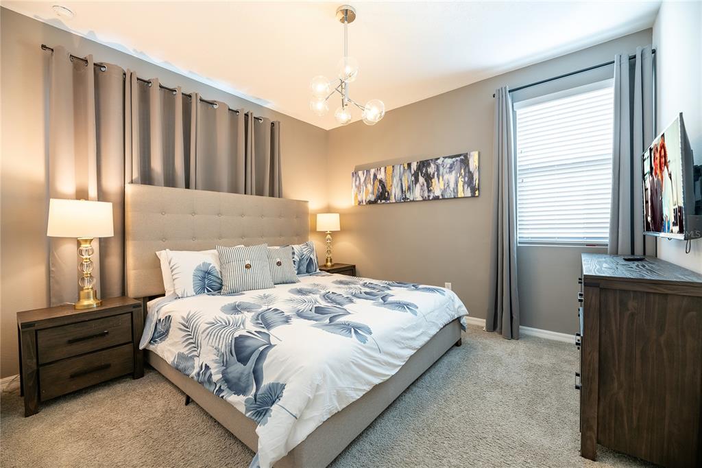 8900 Caroline Bay Court Kissimmee, FL 34747 - Photo 38 of 62 a bedroom with a bed and a window