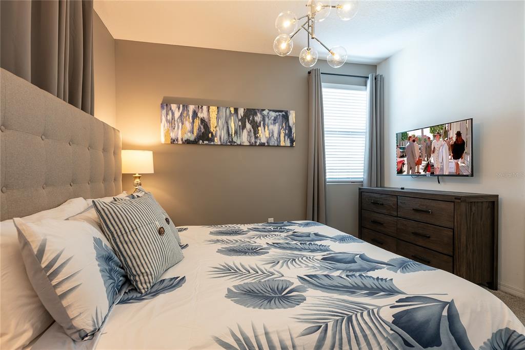 8900 Caroline Bay Court Kissimmee, FL 34747 - Photo 39 of 62 a bedroom with a bed and a dresser