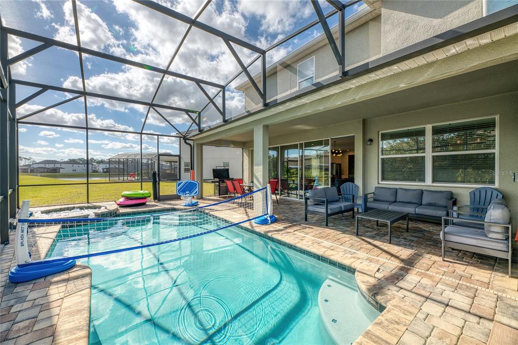 8900 Caroline Bay Court Kissimmee, FL 34747 - Photo 42 of 62 a swimming pool with outdoor seating and yard
