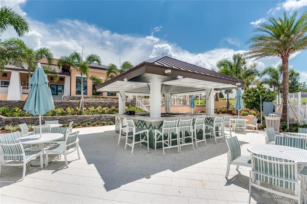 8900 Caroline Bay Court Kissimmee, FL 34747 - Photo 47 of 62 a view of a patio with dining table and chairs with plants