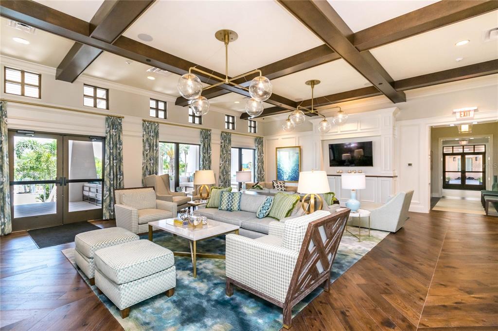 8900 Caroline Bay Court Kissimmee, FL 34747 - Photo 48 of 62 a living room with couches a fireplace and a dining table with wooden floor