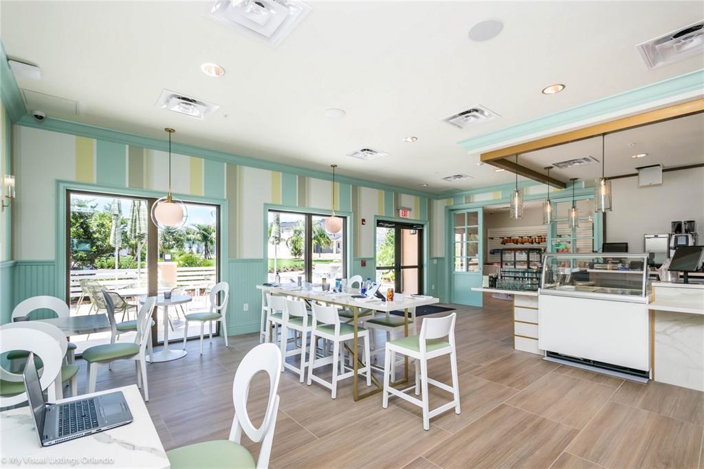 8900 Caroline Bay Court Kissimmee, FL 34747 - Photo 50 of 62 a dining room with wooden floor and white walls