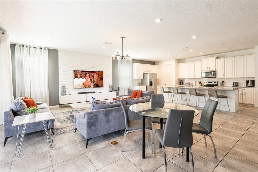 8900 Caroline Bay Court Kissimmee, FL 34747 - Photo 5 of 62 a living room with furniture and a flat screen tv