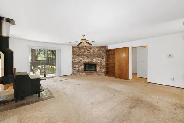 an empty room with furniture and a fireplace
