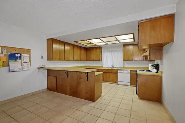 a kitchen with stainless steel appliances granite countertop a sink and cabinets