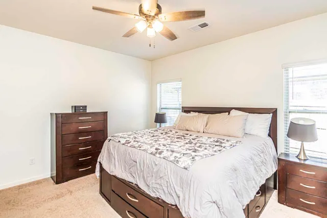 a bedroom with a bed and a chandelier