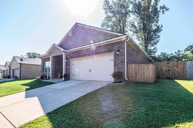 a view of a house with yard and a garden