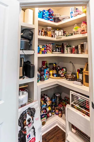 a living room with furniture and a book shelf