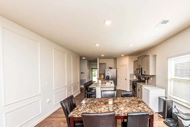 a kitchen with a table and chairs in it