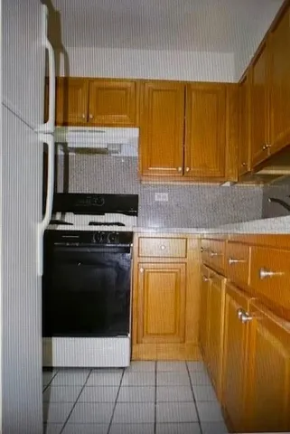 a kitchen with stainless steel appliances a stove a microwave and cabinets