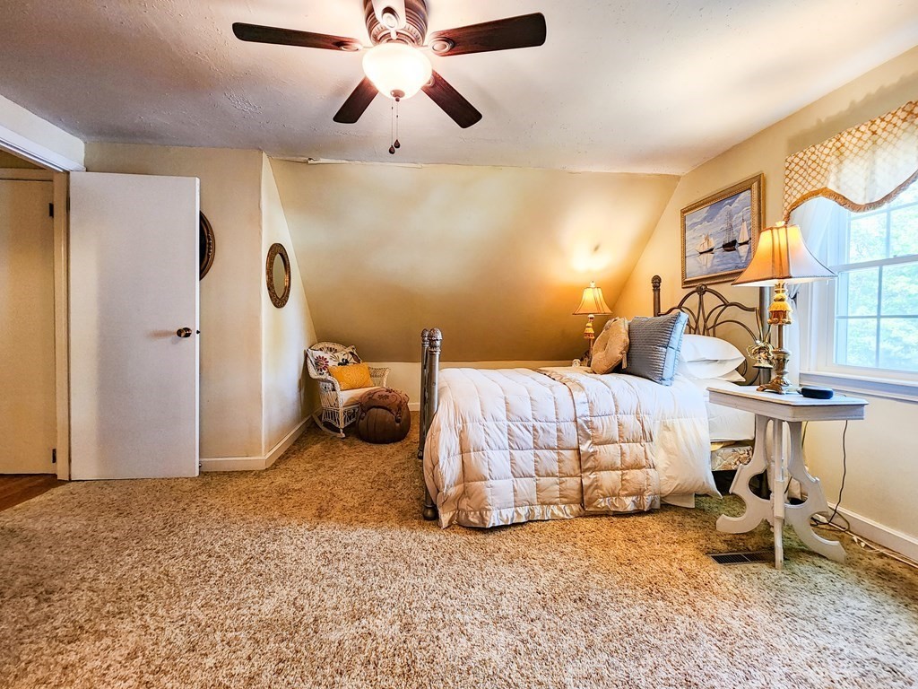 12 Peaceful Lane Wareham, MA 02538 - Photo 24 of 41 a bedroom with a bed and a chandelier