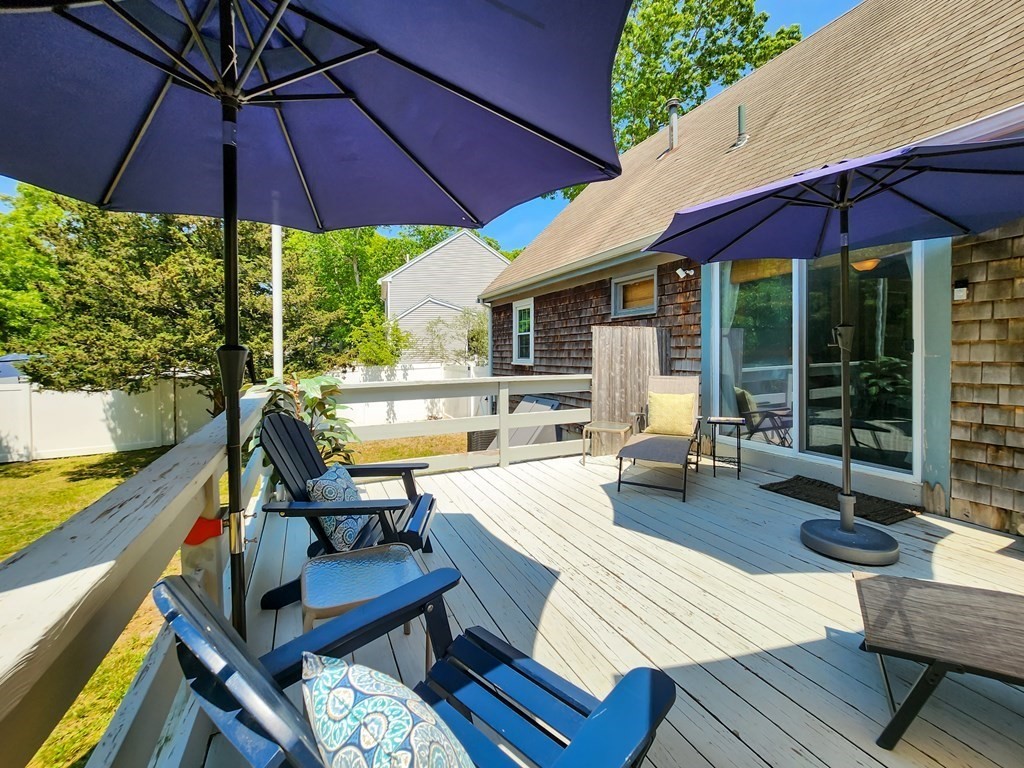 12 Peaceful Lane Wareham, MA 02538 - Photo 28 of 41 a view of a patio with table and chairs under an umbrella