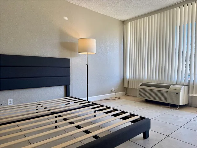 a bedroom with a bed and a night stand