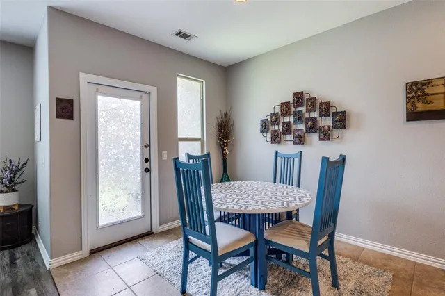 a view of a dining room with furniture and window