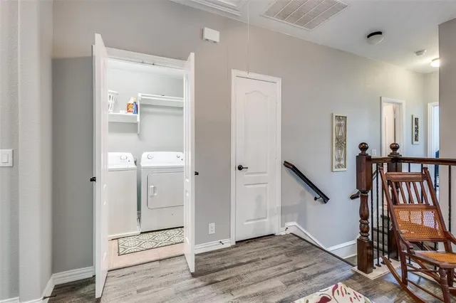 wooden floor in a hall with an entryway and a livingroom