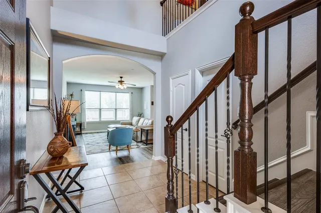 a living room with furniture and stairs