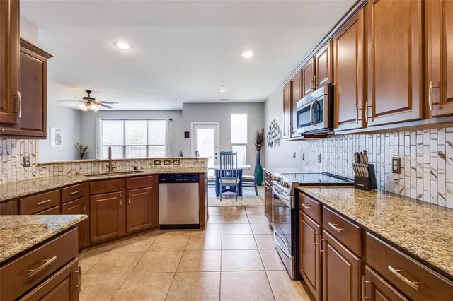 a large kitchen with granite countertop lots of counter top space