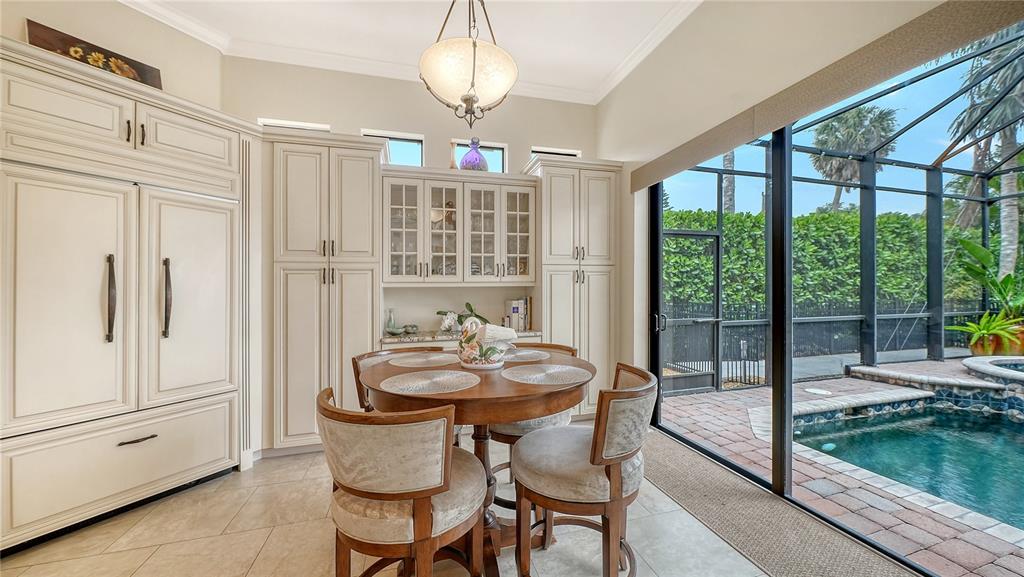 1630 Assisi Drive, Unit 18 Sarasota, FL 34231 - Photo 13 of 42 a dining room with furniture a chandelier and wooden floor