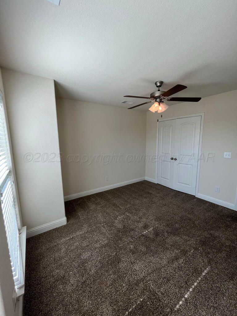 7206 Sinclair Street Amarillo, TX 79119 - Photo 16 of 21 an empty room with a ceiling fan and window