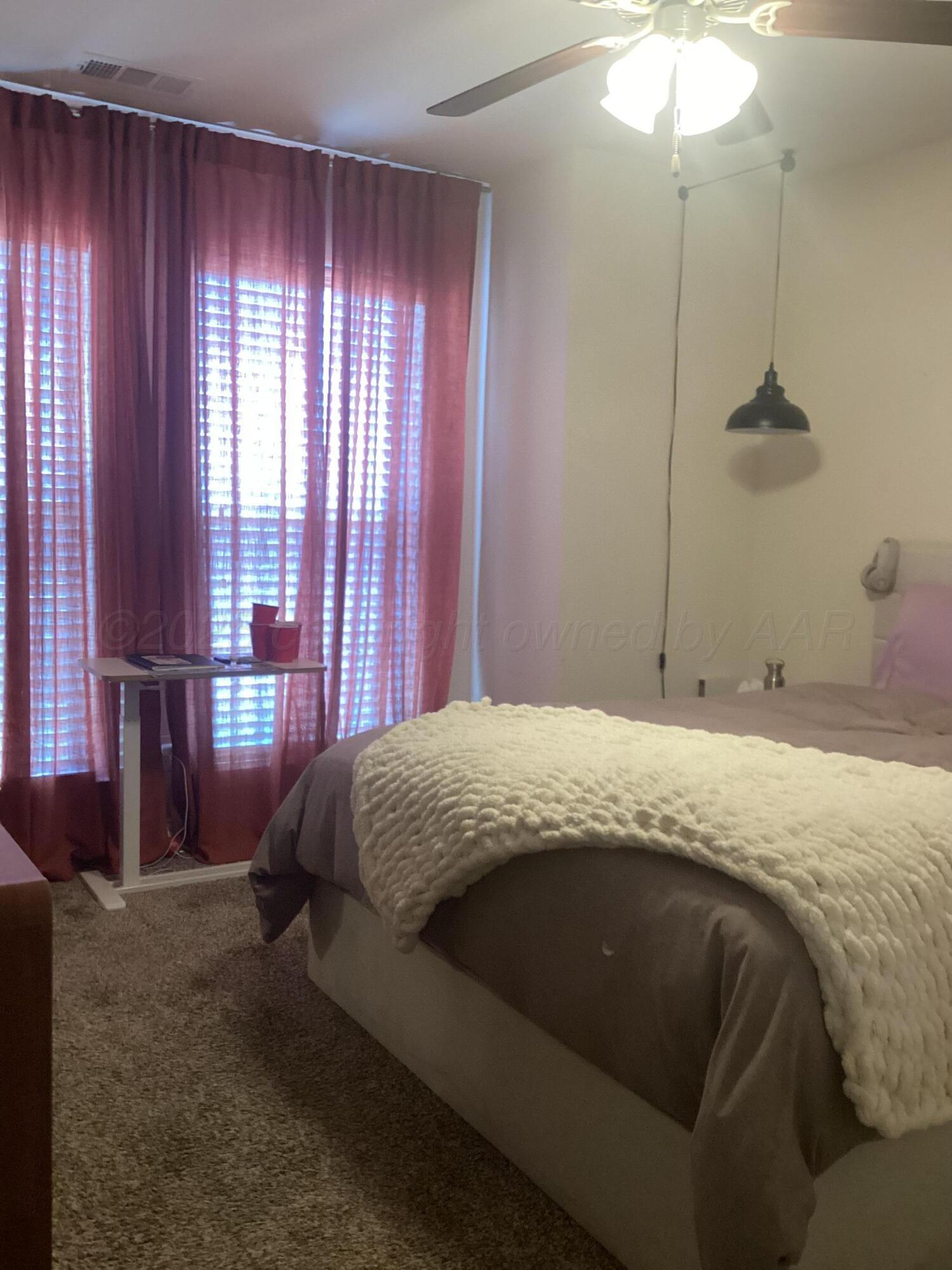 7206 Sinclair Street Amarillo, TX 79119 - Photo 19 of 21 a bedroom with a bed and window