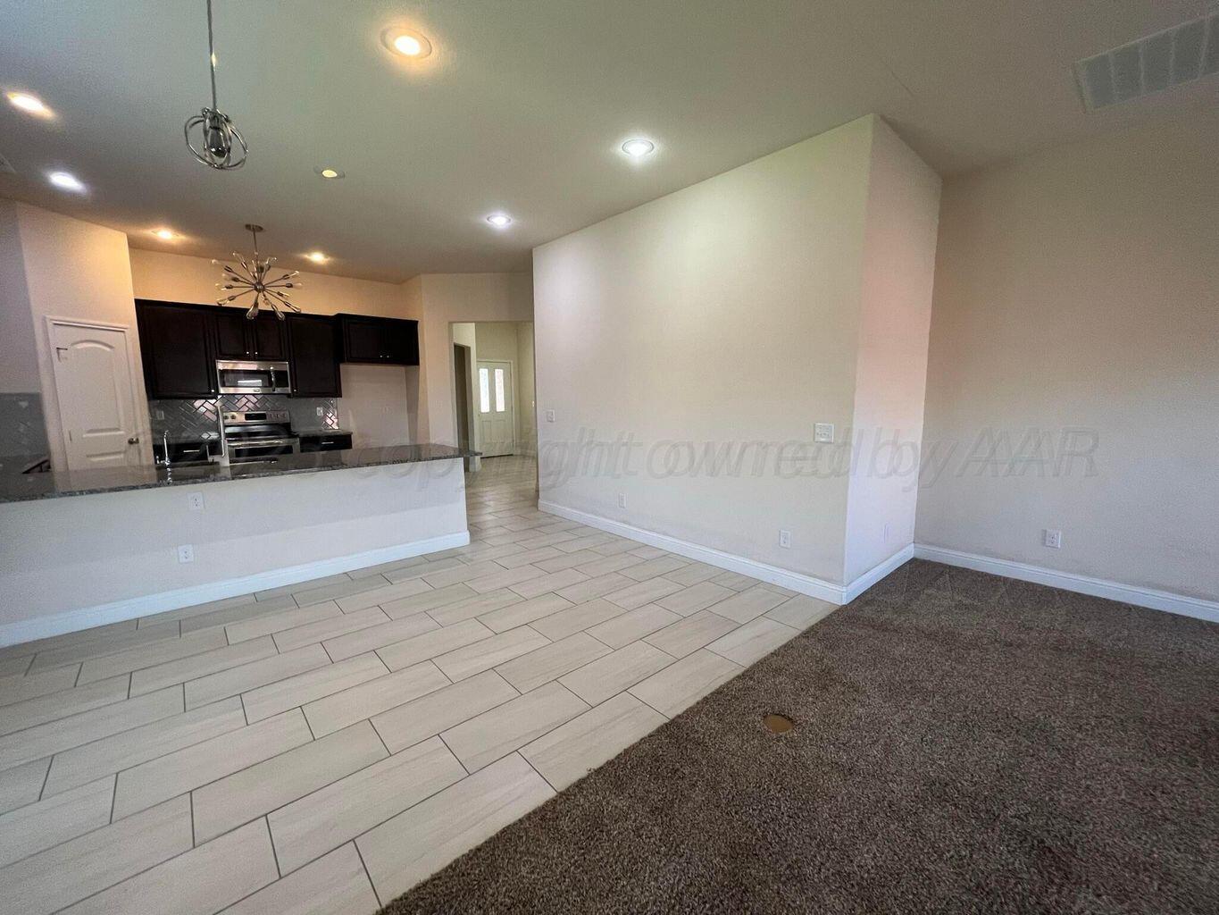 7206 Sinclair Street Amarillo, TX 79119 - Photo 5 of 21 a view of a hall and kitchen