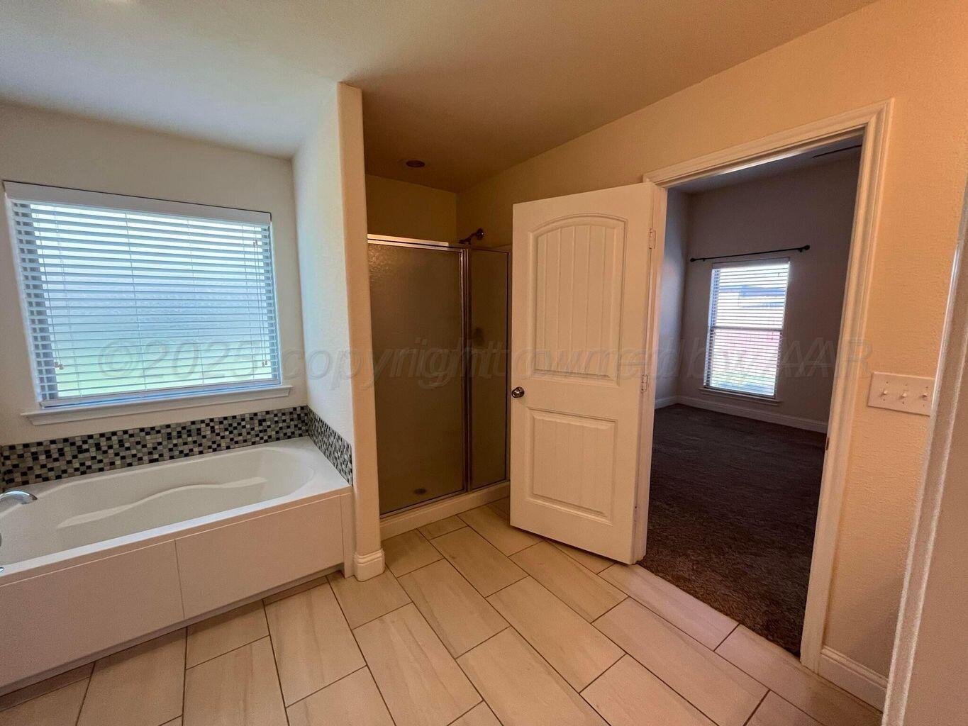 7206 Sinclair Street Amarillo, TX 79119 - Photo 8 of 21 a bathroom with a bathtub and a shower